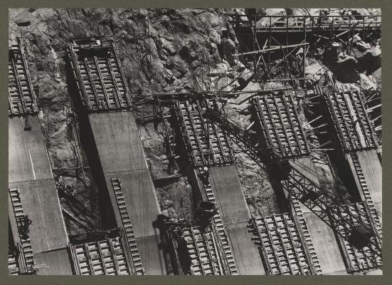 Boulder Dam, (i.e. Hoover Dam) between Arizona and Nevada. Placing concrete in the sidewall of the Nevada spillway. A 2 cubic yard bottom-dump bucket is being handled by crane. June 1933 (Library of Congress Prints and Photographs Division Washington, D.C.)